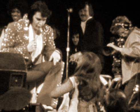 Elvis greets a fan as movie cameras roll for MGM's Elvis On Tour documentary, Richmond Coliseum, April 10, 1972
